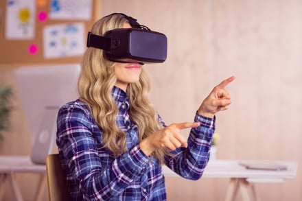 Pretty casual worker using oculus rift in her office