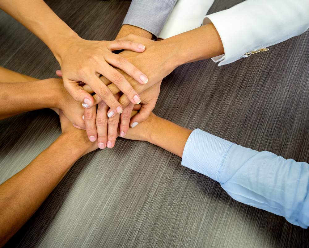 Business team in a meeting with their hands together