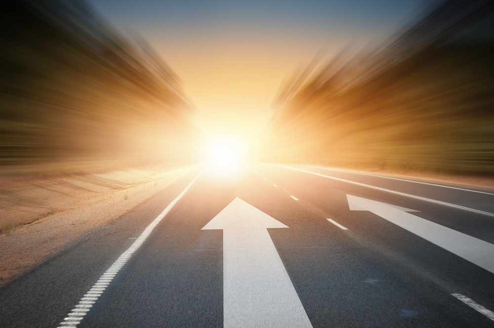 Conceptual image of asphalt road and direction arrow